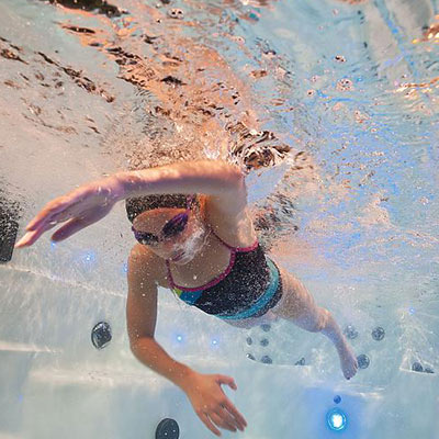 Girl swimming in an H2X swim spa