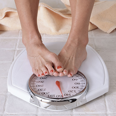 Close up of weighing scale with feet on it